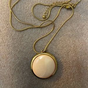 Pink and gold circle pendant necklace.